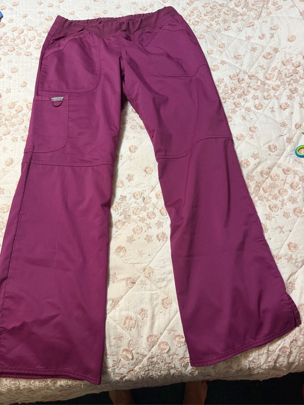 Cherokee work wear scrub pants in the color wine.